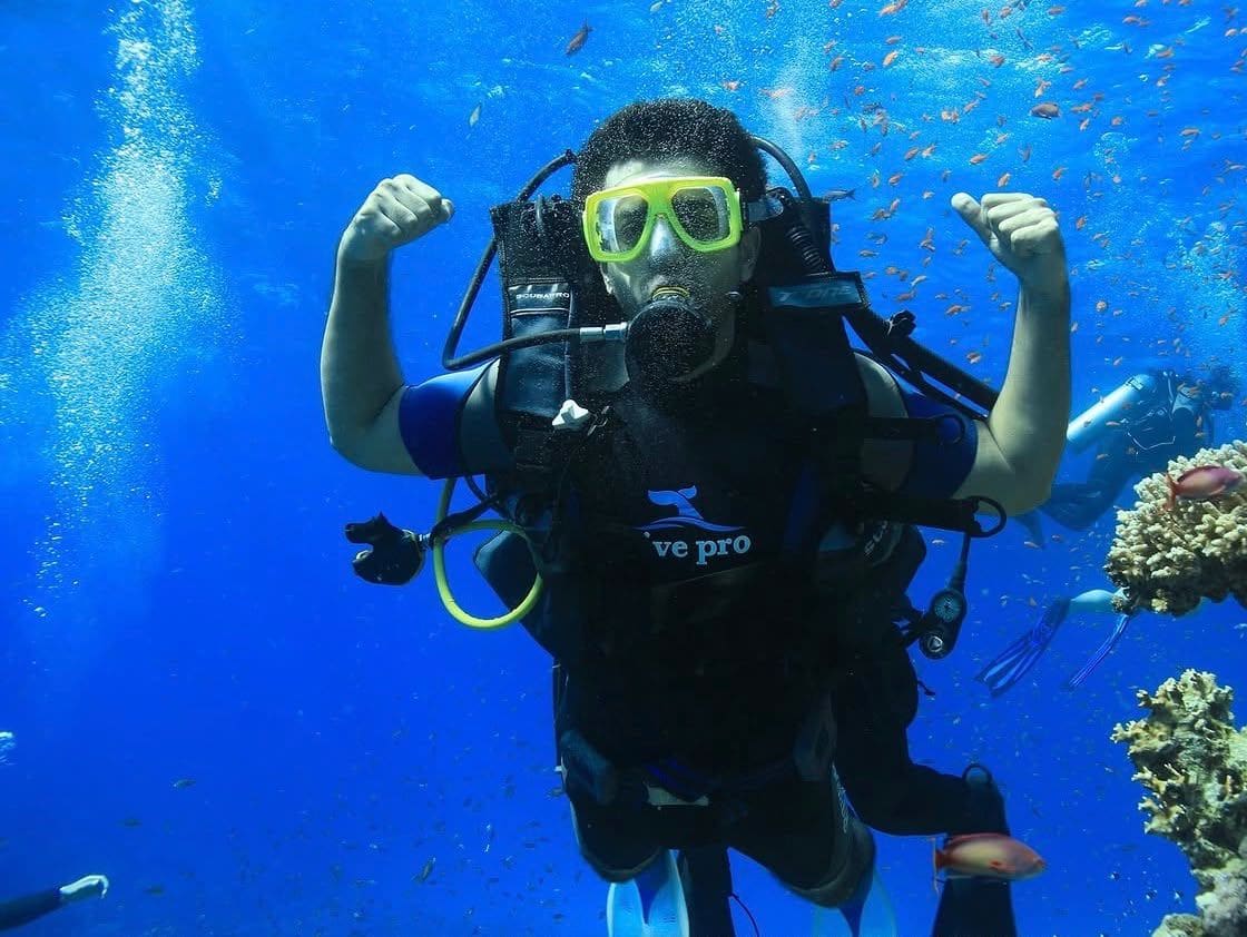 Malik Hamza Javed scuba diving next to a coral reef